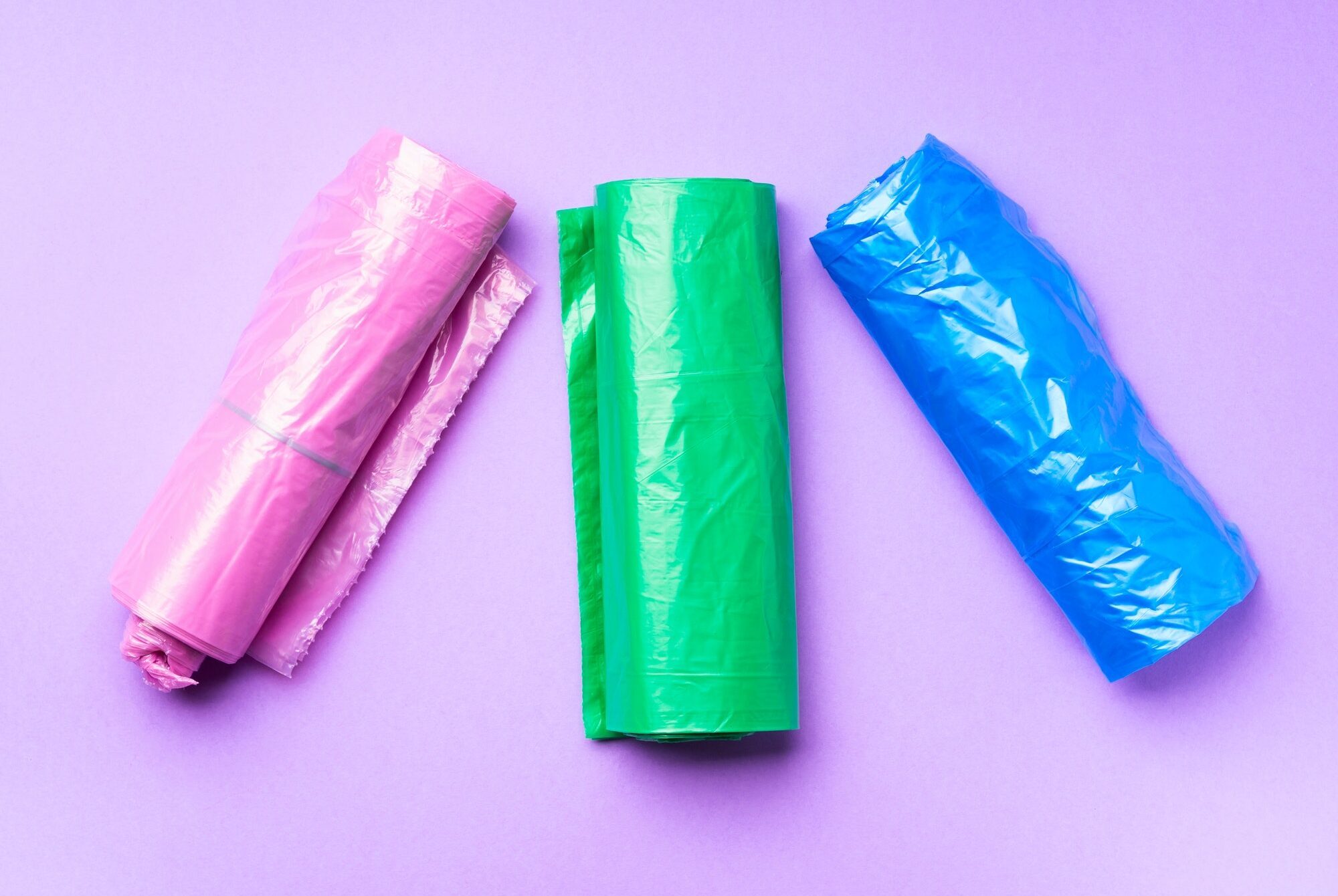 Plastic bags colorful rolls on purple background
